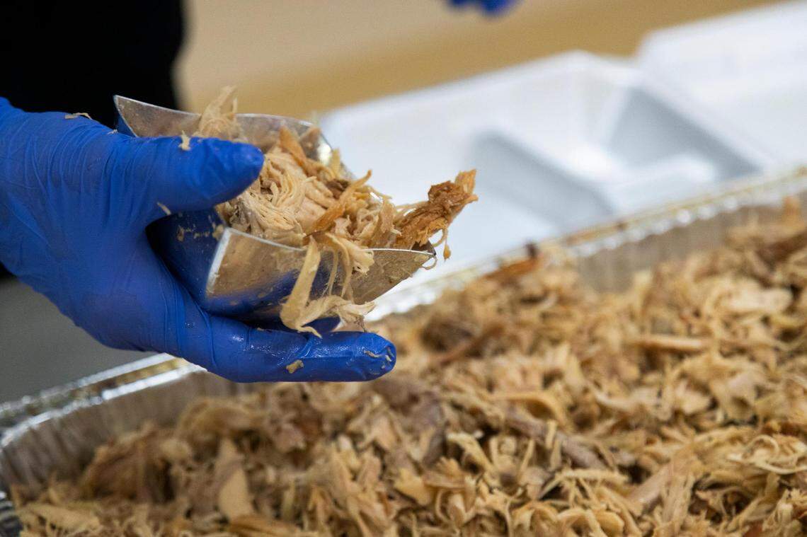 Members of churches across Columbia prepare a Thanksgiving lunch at The Basilica of St. Peter in downtown Columbia, South Carolina on Thursday, November 26, 2020. Organizer Robert Keeder said that the event attracted fewer volunteers than normal.