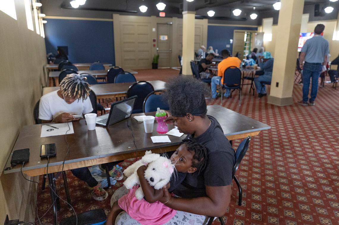 Menda Shelton and her children, Xavier Shelton, 14, and India Shelton, 1, rest and work at the Old Newberry Fire Sation on Monday, Sept 30, 2024 where they could use the internet and charge their phones. The Sheltons live in the community of Joanna and had no power after strong winds and rain blew through from Hurricane Helene.