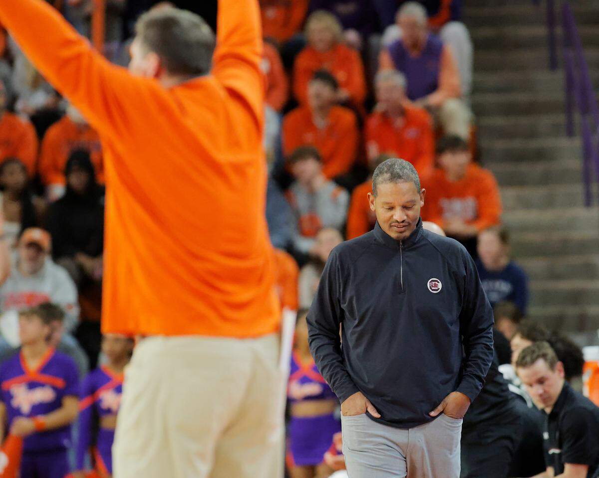 South Carolina head coach Lamont Paris, right, is seen as Clemson head coach Brad Brownell talks to his team during second-half action in Clemson, S.C. on Tuesday, Dec. 16, 2025.