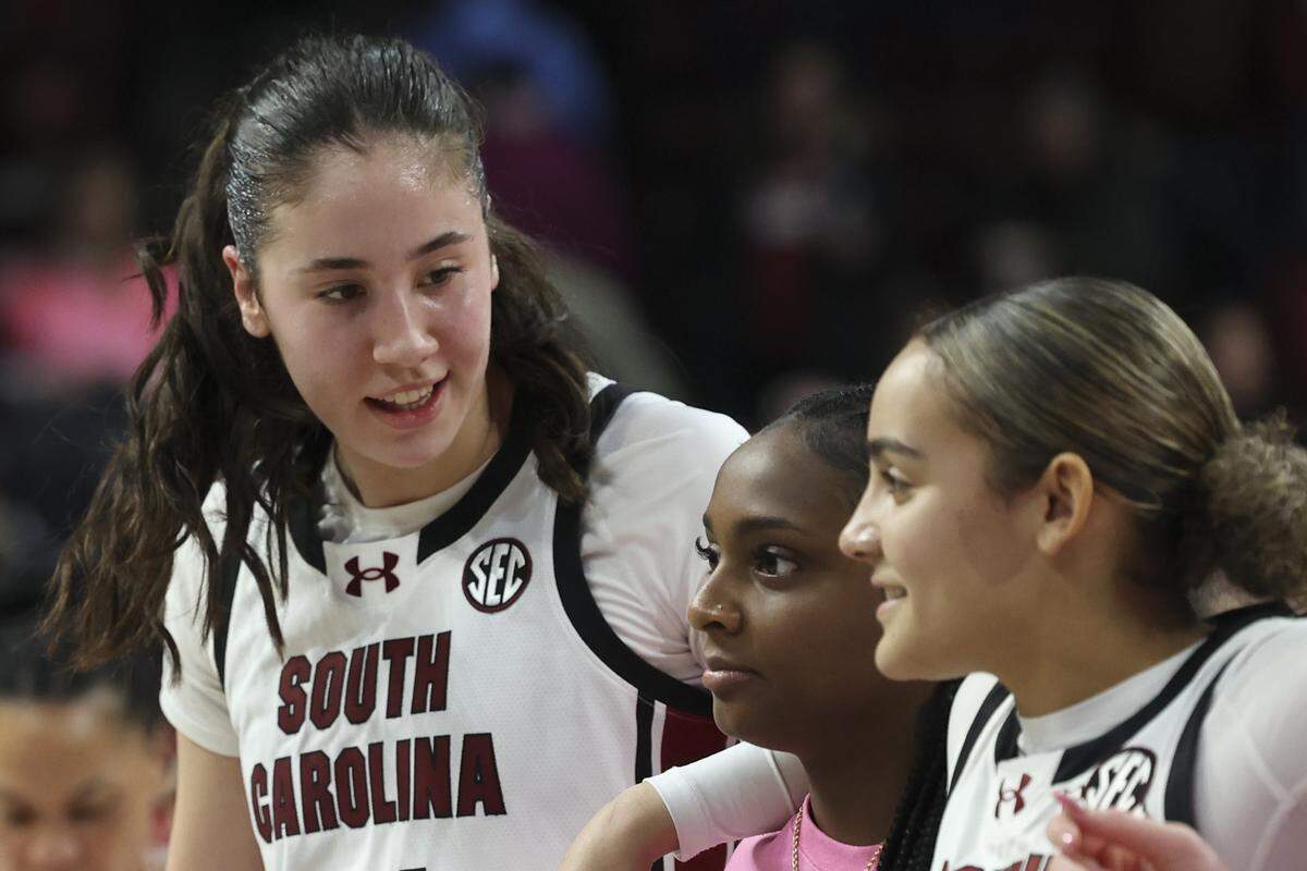 South Carolina's Alicia Tournebize stands with South Carolina's Ta'Niya Latson (00) and South Carolina's Tessa Johnson (5) during the post game alma mater of their women's basketball game against Ole Miss at Colonial Life Arena on Thursday, Feb. 5, 2026.