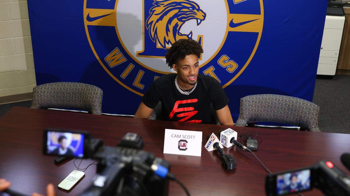 Basketball player Cam Scott speaks during an interview following a signing ceremony at Lexington High School in Lexington on Wednesday, April 17, 2024.