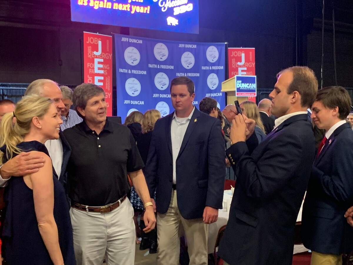 Cody Simpson, who has been appointed state executive director for the South Carolina Farm Service Agency, takes a photo Gov. Henry McMaster and supporters at the Jeff Duncan Faith and Freedom Barbecue in August 2022.