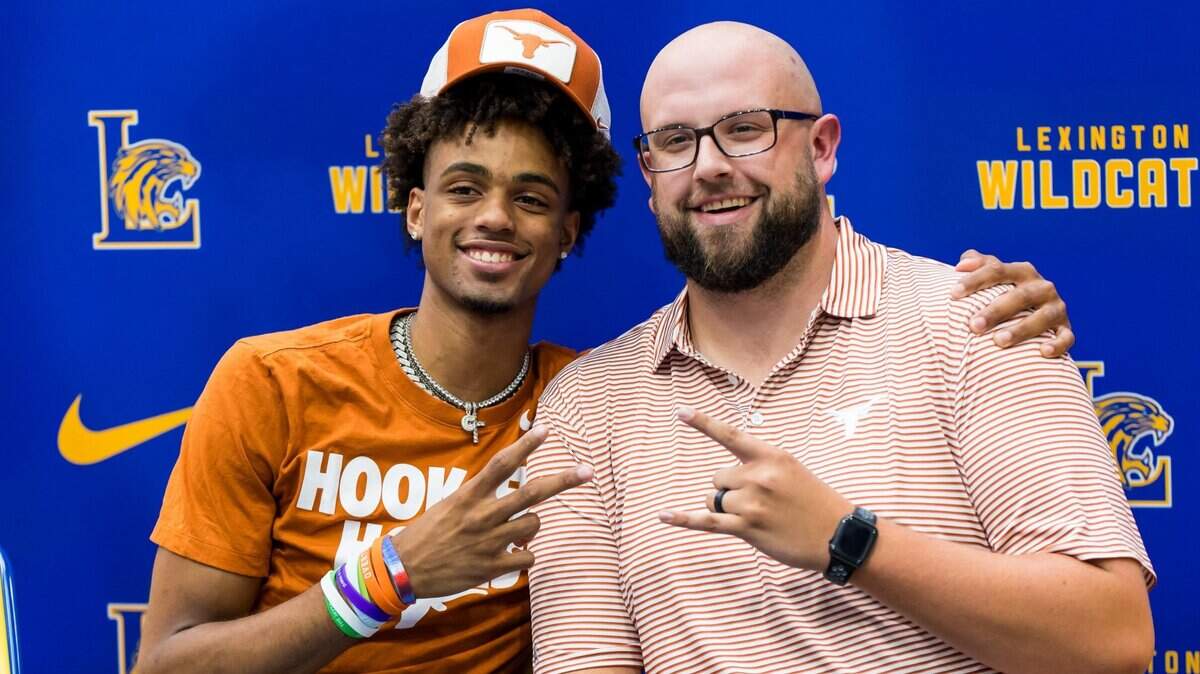 Lexington High School student/athlete Cam Scott poses with his basketball coach Elliott Pope during his commitment announcement at his high school in Lexington, SC, Friday, August 11, 2023. Scott will play for the Texas Longhorns.