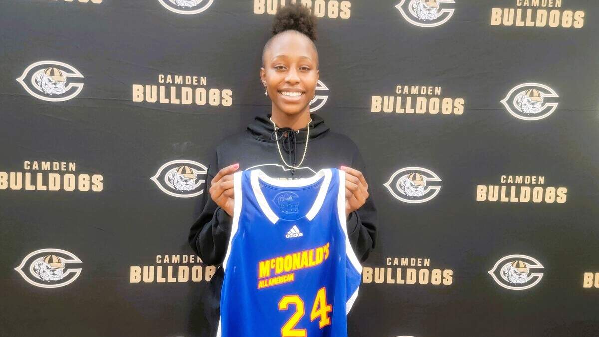 Camden High’s Joyce Edwards receives her jersey for being named to McDonald’s All-American game.