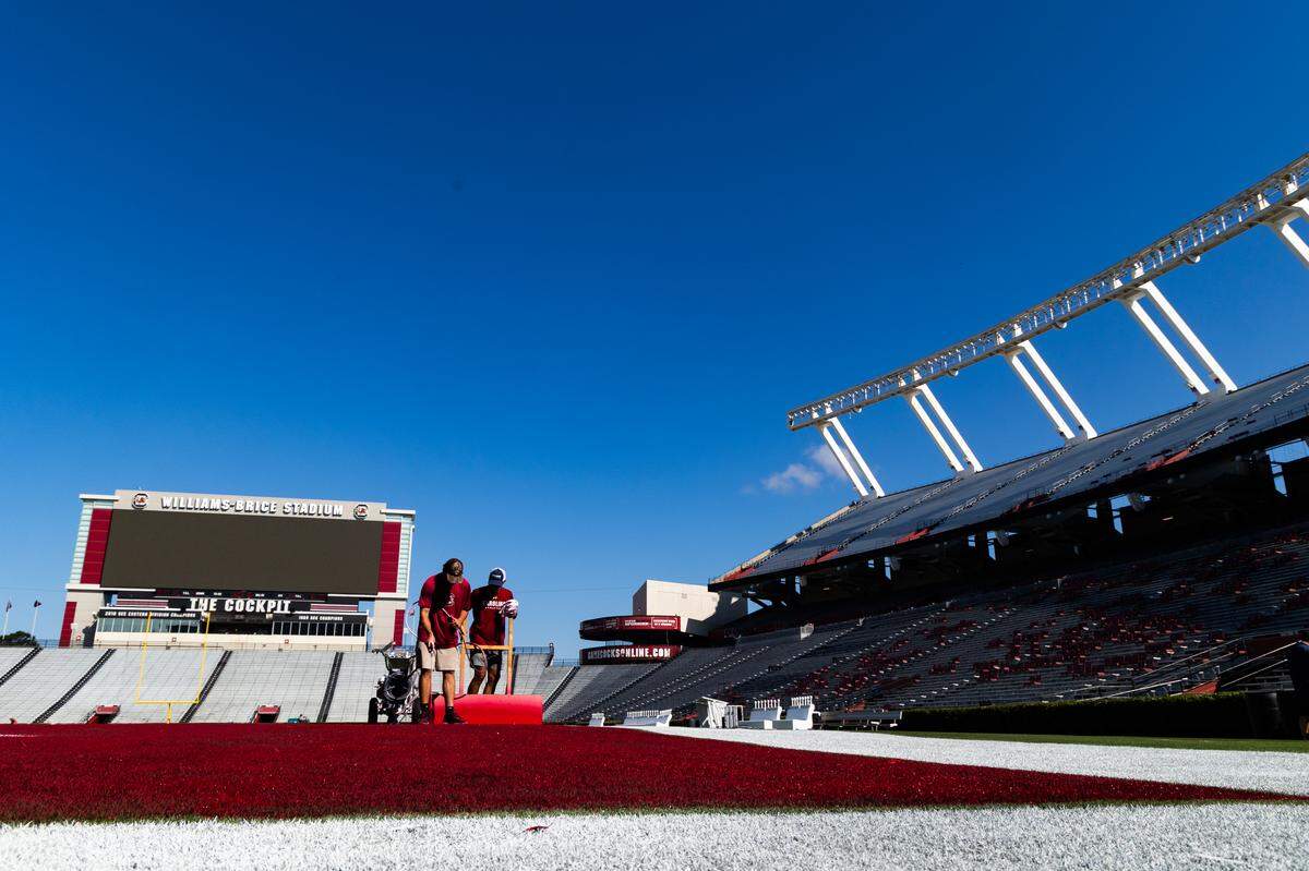 Workers at the University of South Carolina paint the field at Williams-Brice Stadium on Friday, September 12, 2025.