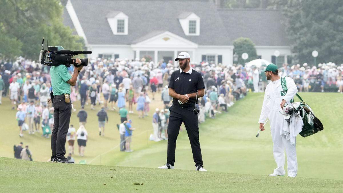A camera stays focused on Dustin Johnson as he moves down the first fairway during the 2023 Masters golf tournament