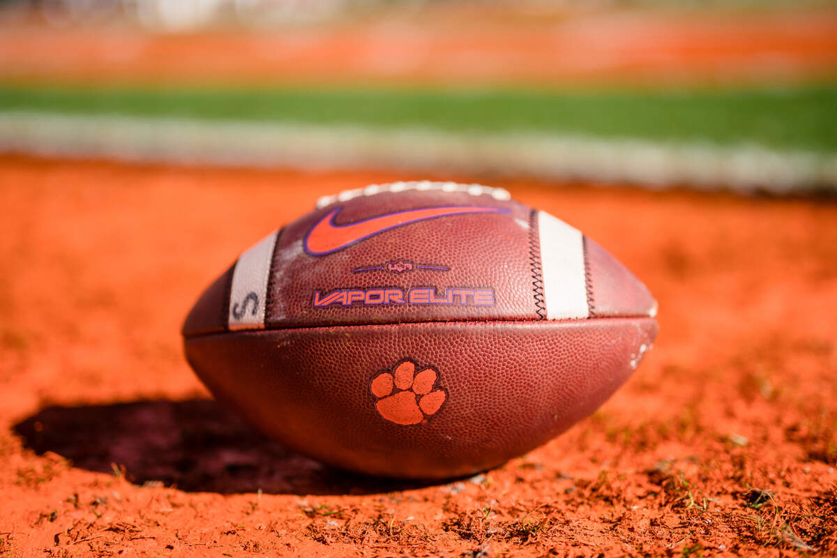 A Clemson football lies on the field before an NCAA college football game against South Carolina on Saturday, Nov. 26, 2022, in Clemson, S.C. (AP Photo/Jacob Kupferman)