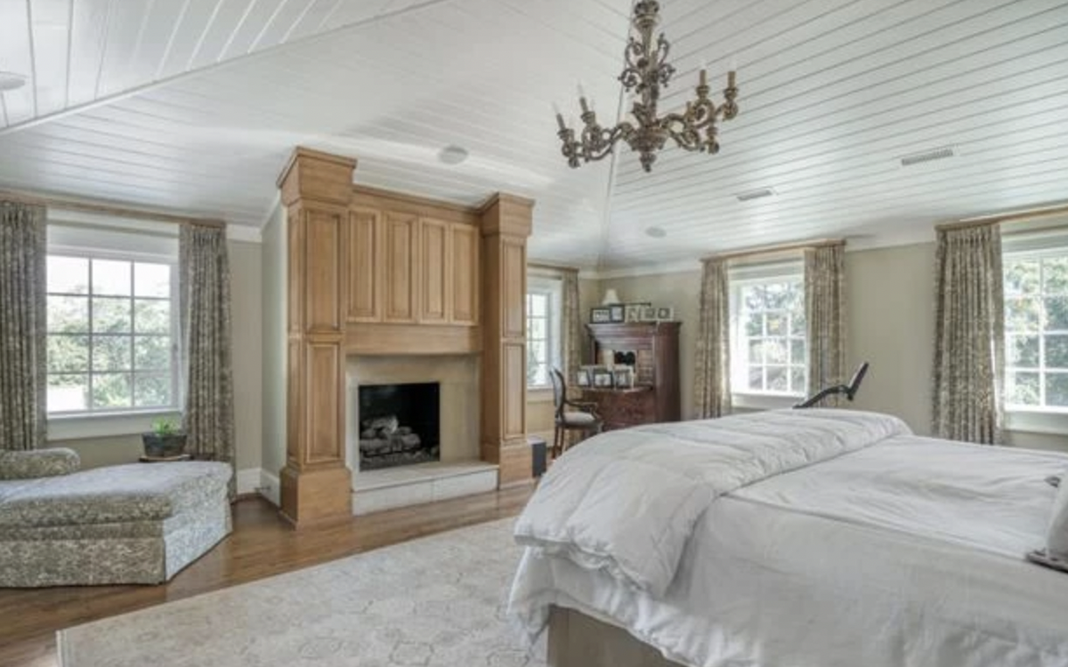 The master suite includes vaulted ceilings, a fireplace, a small office and views of Paris Mountain.