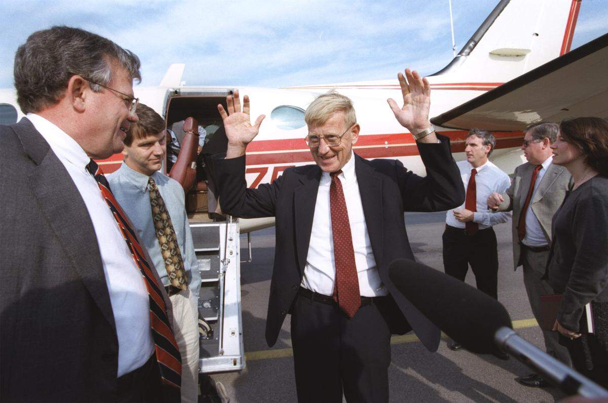 A jubilant Lou Holtz (center) leaves the plane and is welcomed by USC Athletic Director Mike McGee (left) on Dec. 14, 1998, before he was officially introduced as the new head coach of the USC Gamecocks.  The former Notre Dame coach, which took Fighting Irish to a national championship in 1988, is 216-96-7 overall. 