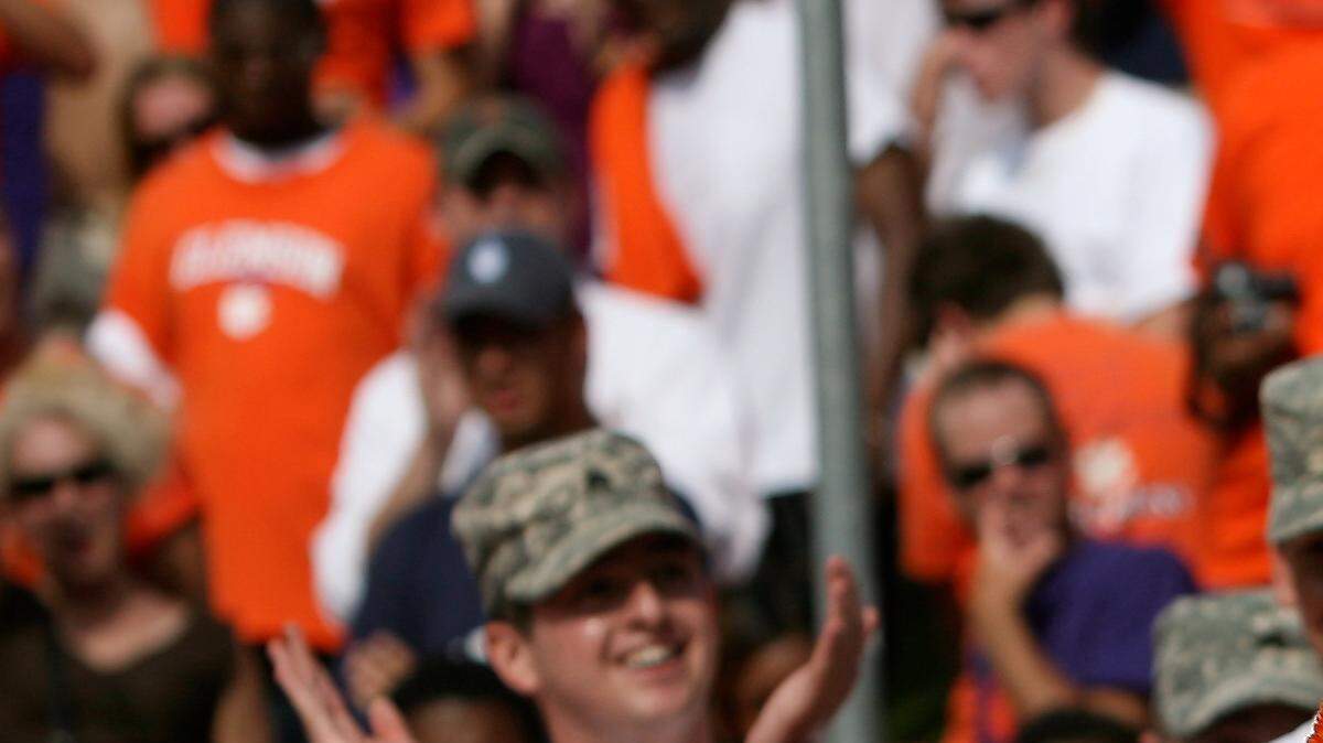Clemson Presiden James Barker waves to the fans dressed as The Tiger in September 2008.  Barker did push-ups, counting up the number of points Clemson had scored, before taking off the tiger head and revealing himself.