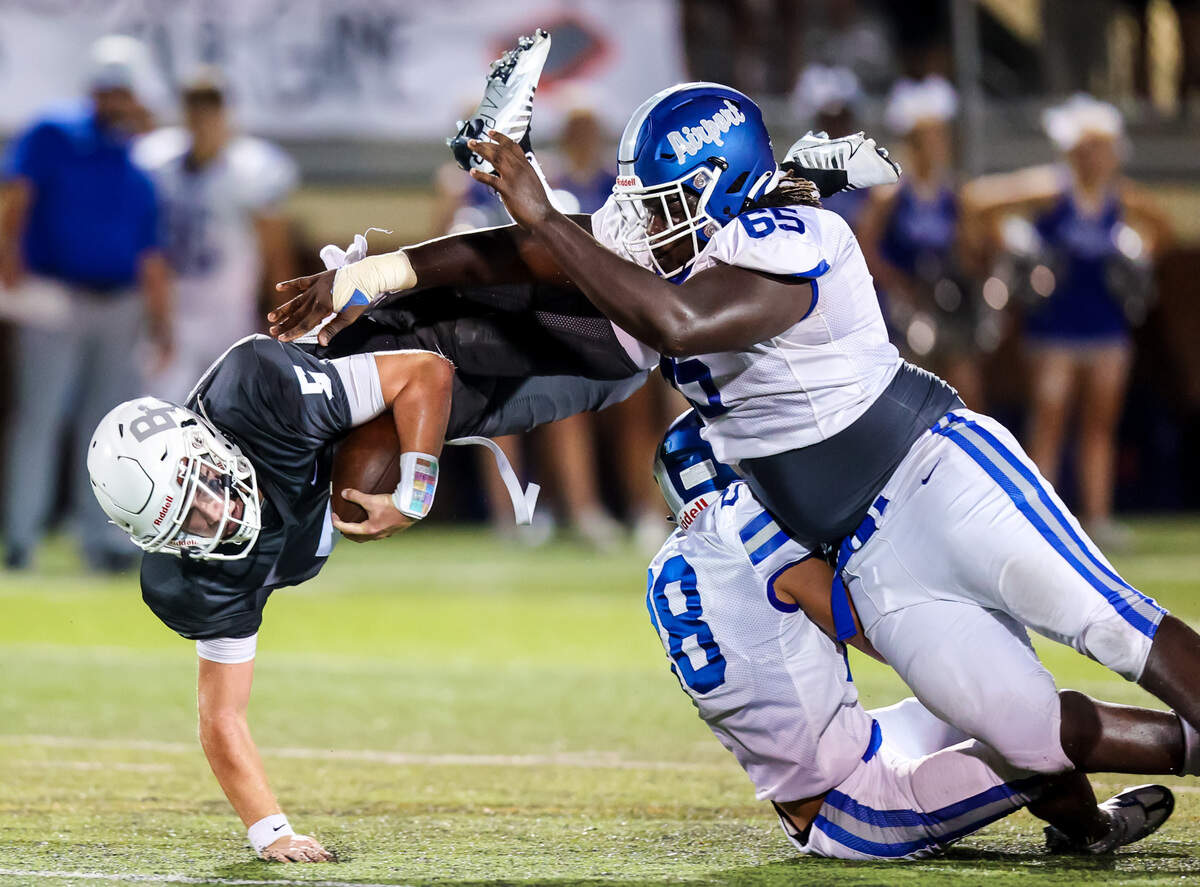 Brookland-Cayce quarterback Tanner Staton (5) gains yardage as he’s upended by Airport’s DJ McFadden (65) during their game Friday night at Brookland-Cayce High School.