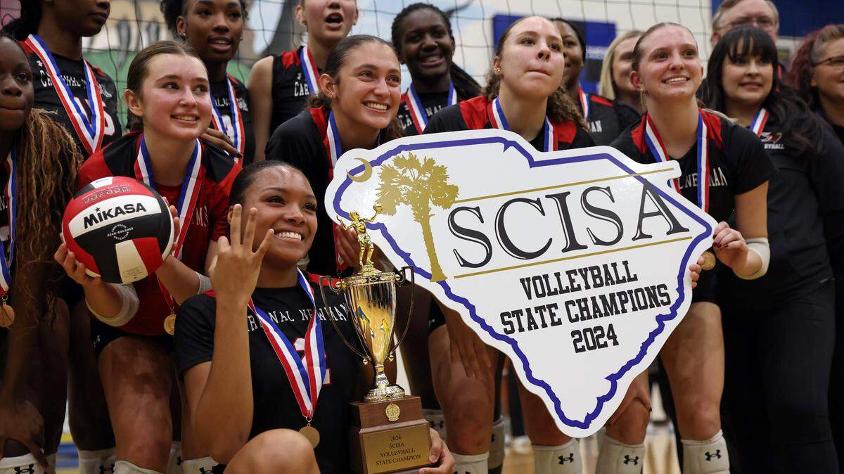 Cardinal Newman volleyball celebrates its 2024 SCISA Class 4A state championship win over Porter-Gaud on Tuesday in a match held at Lexington High School.