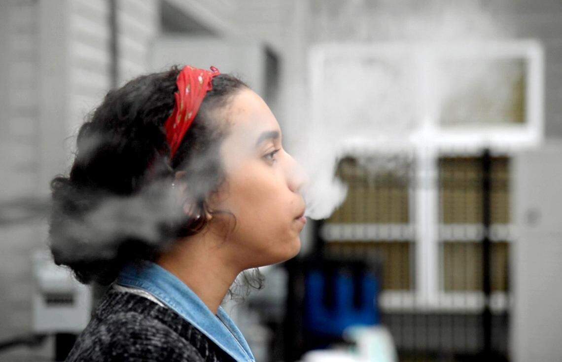 File Photo: Noemi Griffin uses a Juul electronic cigarette while on a quick break at work November 14, 2018.