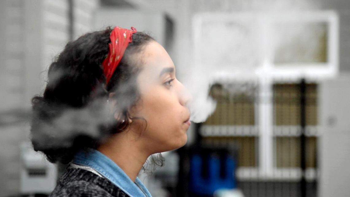 File Photo: A college student in Georgia uses a Juul electronic cigarette while on a quick break at work November 14, 2018.