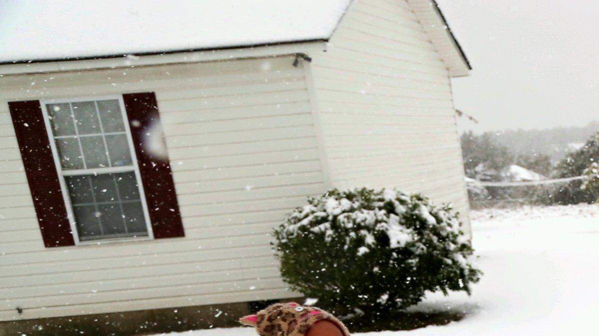 Janiah Nelson and Caleb Caughman play in the unexpected snow in Lexington county.