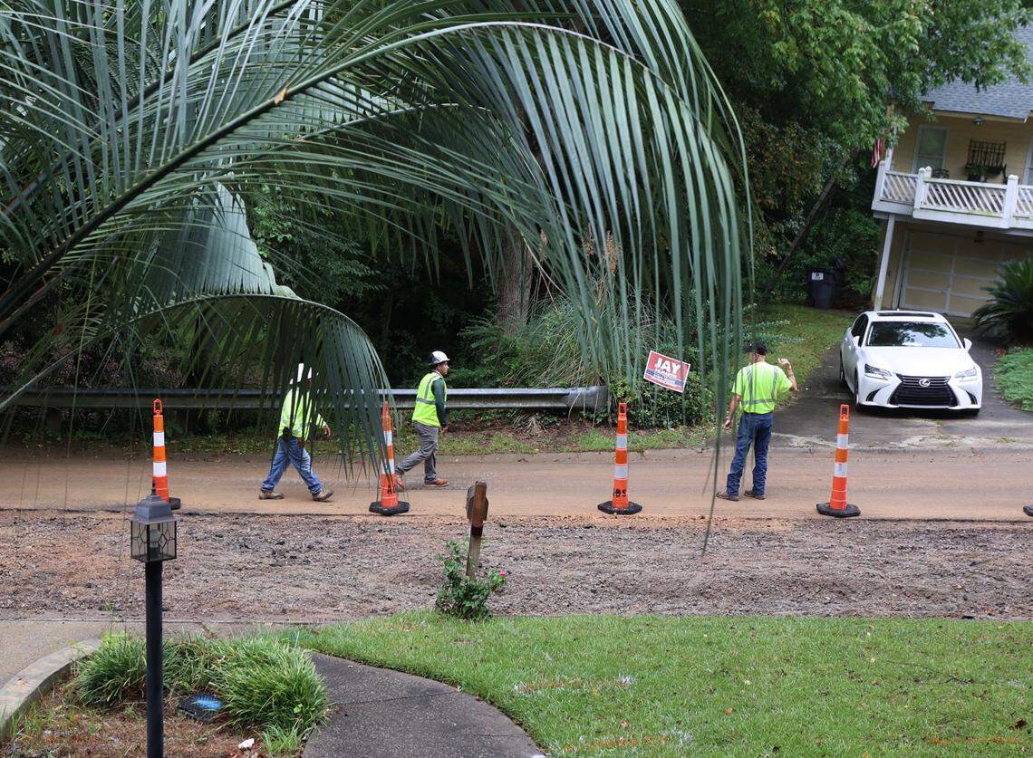 Crews work to repair the road on Willow Bend Court in Irmo where a water line was broken last year as subcontractors for Lumos Fiber were installing cable for fiber optic cable. The broken line created a sinkhole, making the road impassable.