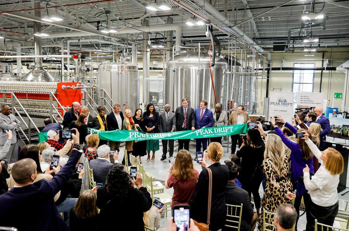 A ribbon is cut during an opening celebration at Peak Drift Brewing in Columbia on Wednesday, Jan. 18, 2023.