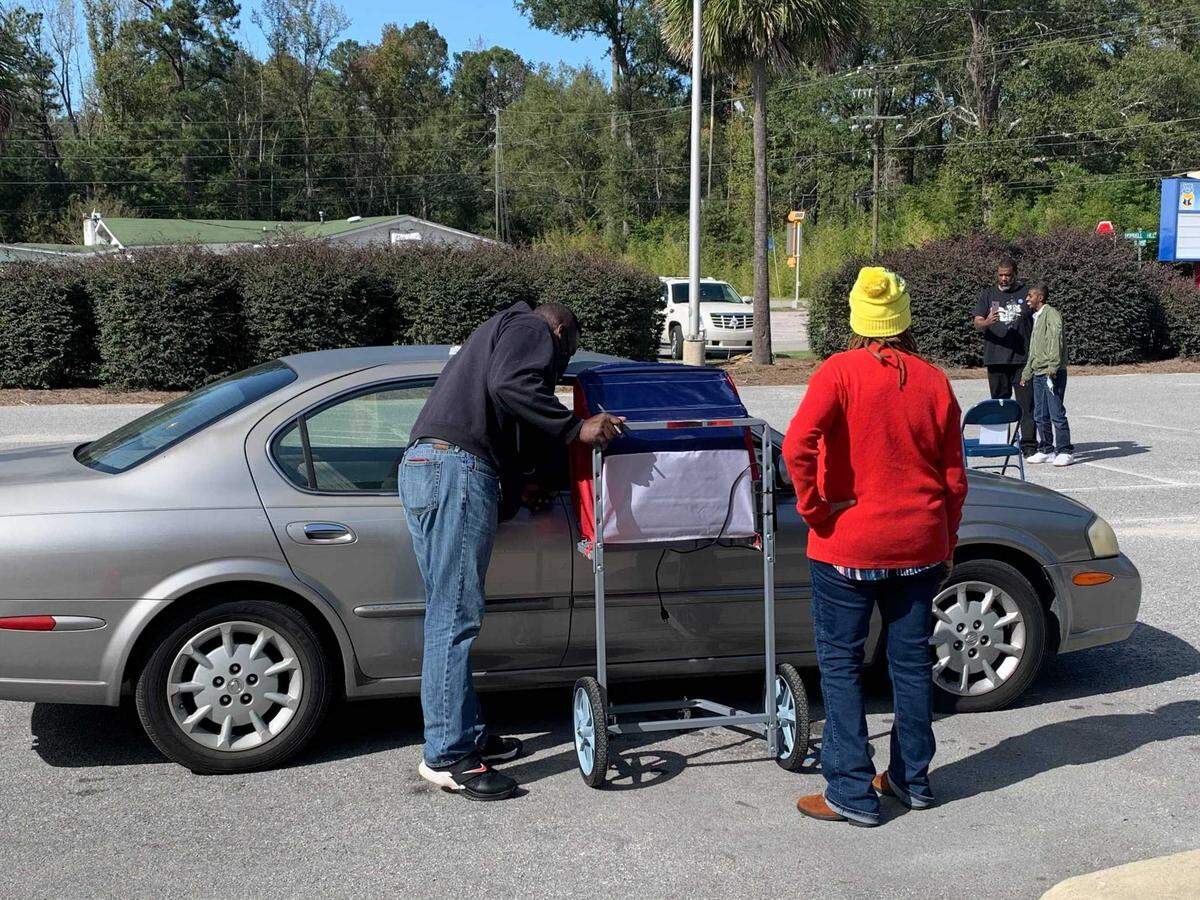 Poll workers assist a curbside voter at Hopkins Elementary School in Lower Richland on Nov. 3, 2020.