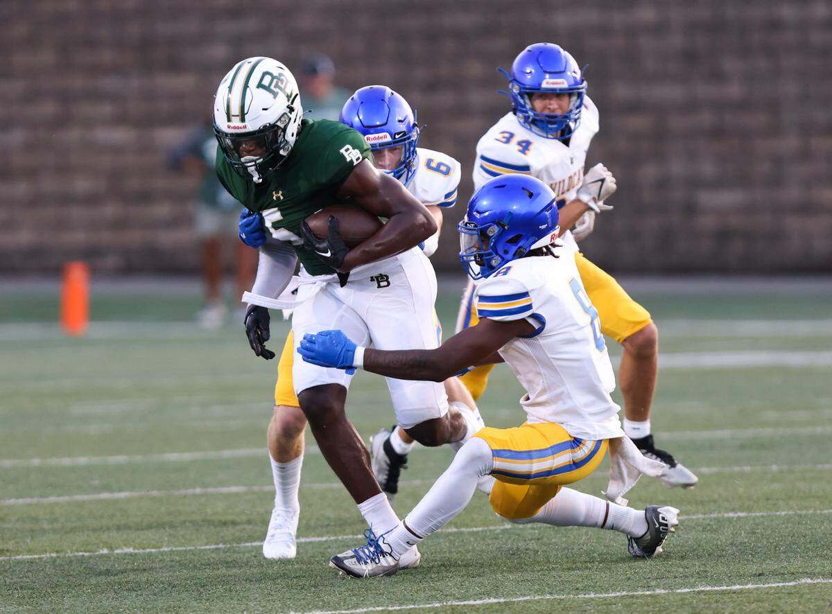 Stephen Collier (5) of River Bluff gets wrapped up by Lexington players during the Lexington One Sports-A-Rama Jamboree at River Bluff High School on on Friday, August 11, 2023.