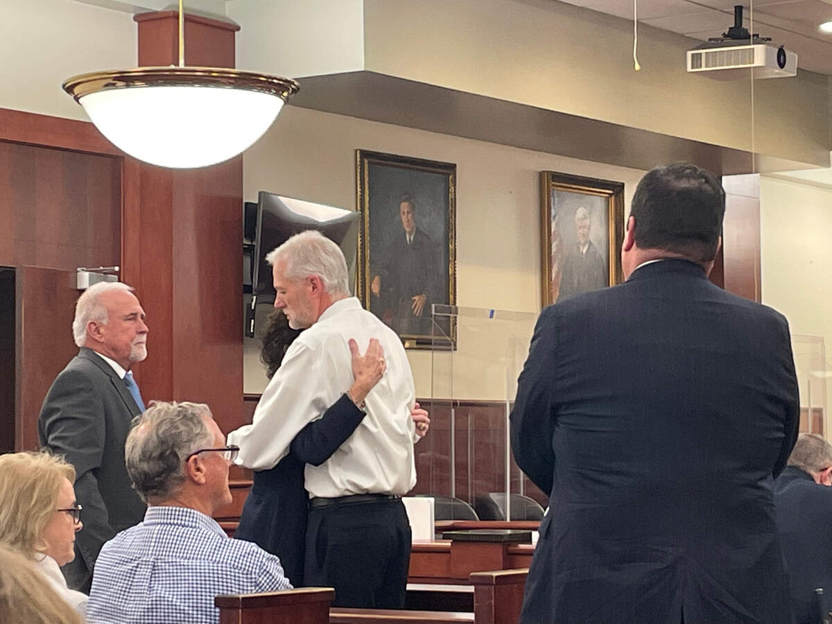 William Player Holland’s mother hugs prosecutor Shawn Graham before the start of the eighth day of the trial against Adam Lazzarini.