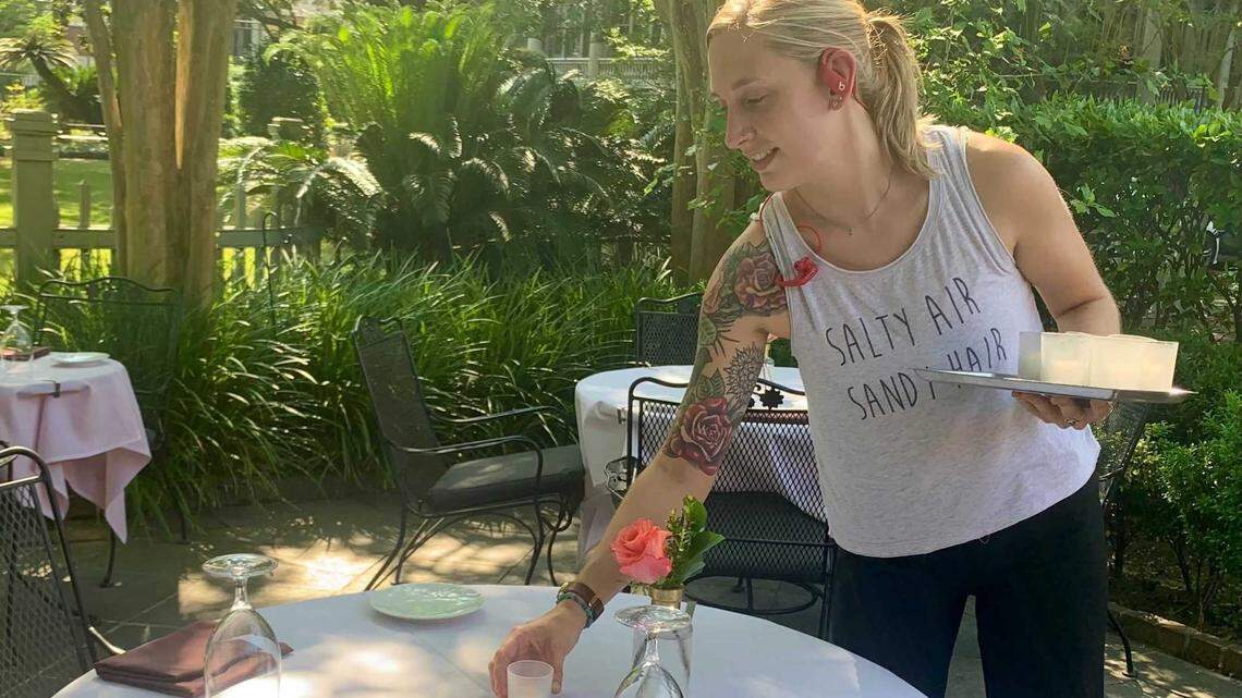 Kait Stine prepares tables at Circa 1886 for dinner service on Thursday, May 27, 2021. The fine dining restaurant is bracing for a busy Memorial Day weekend after a difficult 2020 tourism season.