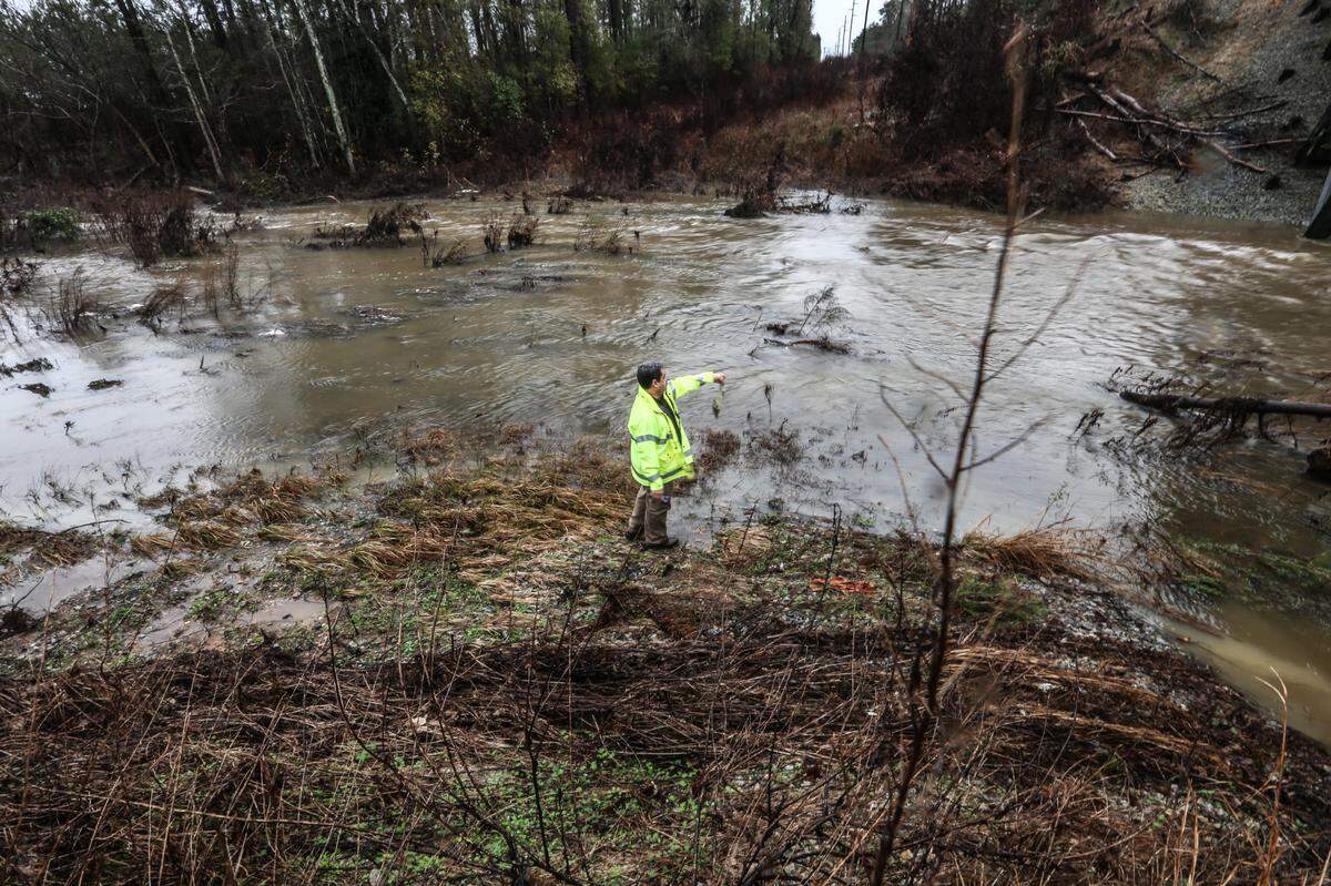 A DHEC dam inspector looks over a dam near Farrow Road in North East Columbia Tuesday October, 6, 2015. after heavy rains filled the lake with water and caused it to spill over the top.