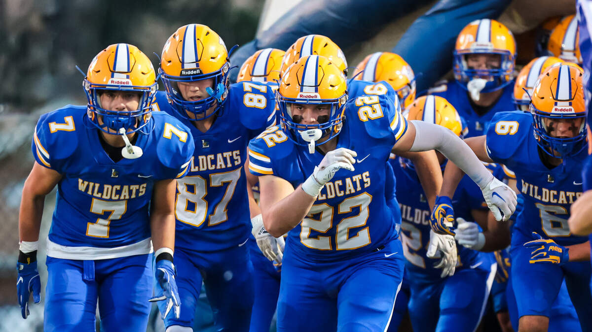 Lexington Wildcats players enter the field before the game against the Gilbert Indians at Lexington High School Friday, Sept. 16, 2022.