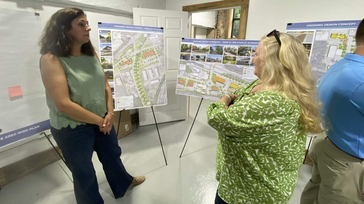 Stantec redevelopment planner Kaitlyn Woolard explains proposed development of the State and Frink Street corridors to long-time resident Joan Hoffman at a public input meeting July 13, 2026.