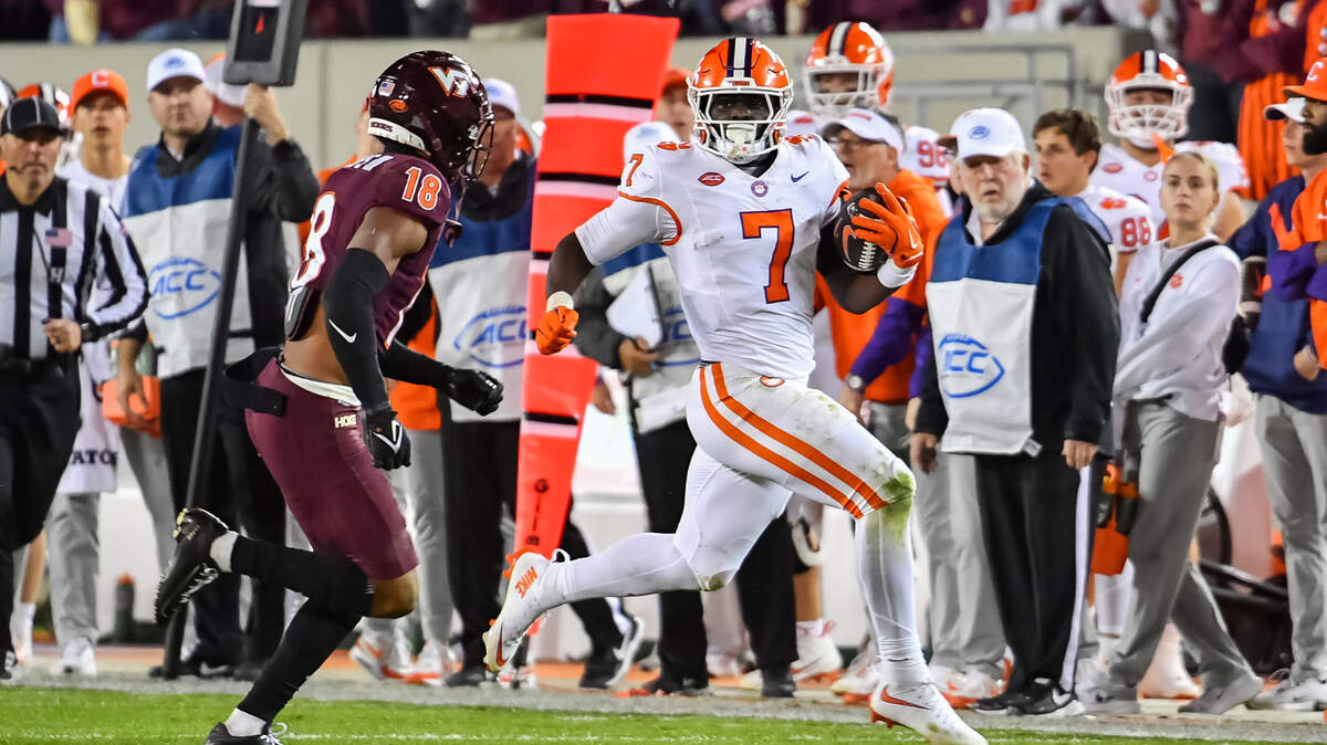 Nov 9, 2024; Blacksburg, Virginia, USA; Clemson Tigers running back Phil Mafah (7) runs down the sideline as Virginia Tech Hokies safety Mose Phillips III (18) looks to force him out of bounds during the third quarter at Lane Stadium.