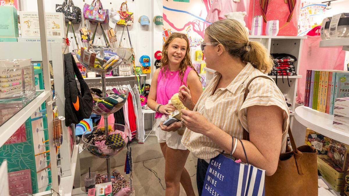 Ginny Bozeman and her daughter, Anna Bozeman, 15, look at sun glasses at A Little Happy in Five Points. The gift shop features a wide variety of gift items, custom ball caps and licensed fraternity and sorority items.