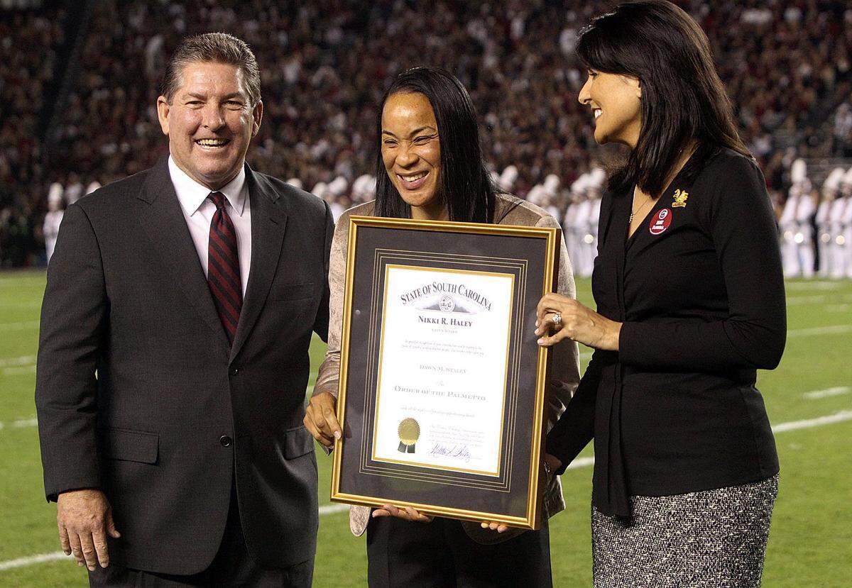 From 2013: Joined by athletic director Ray Tanner, USC’s women’s basketball coach Dawn Staley is awarded the Order of The Palmetto by then Gov. Nikki Haley.