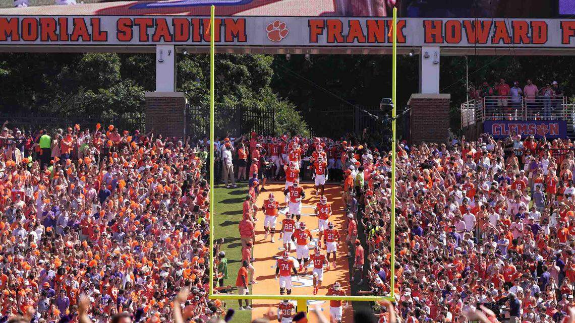 Clemson Tigers players run down the hill prior to a 2023 game against the Florida State Seminoles at Memorial Stadium.