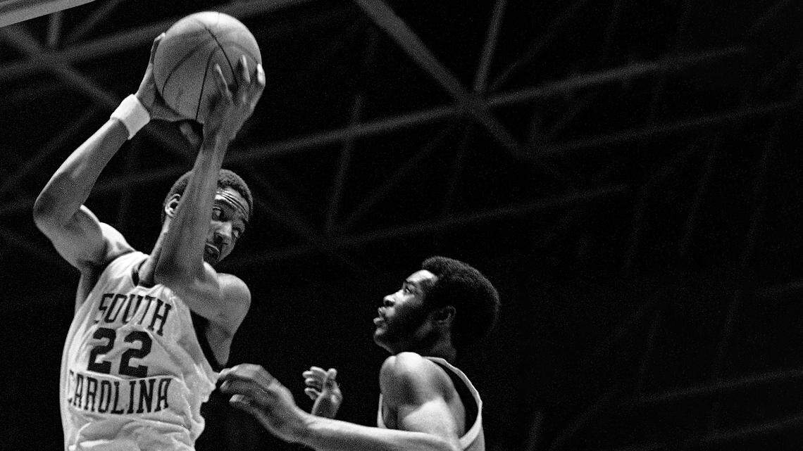 Alex English of the University of South Carolina, left, hangs on to the rebound in a face to face struggle with Earl Tatum (43) of Marquette in game action on Feb. 22, 1975 at Carolina Coliseum in Columbia. (AP Photo/LK)
