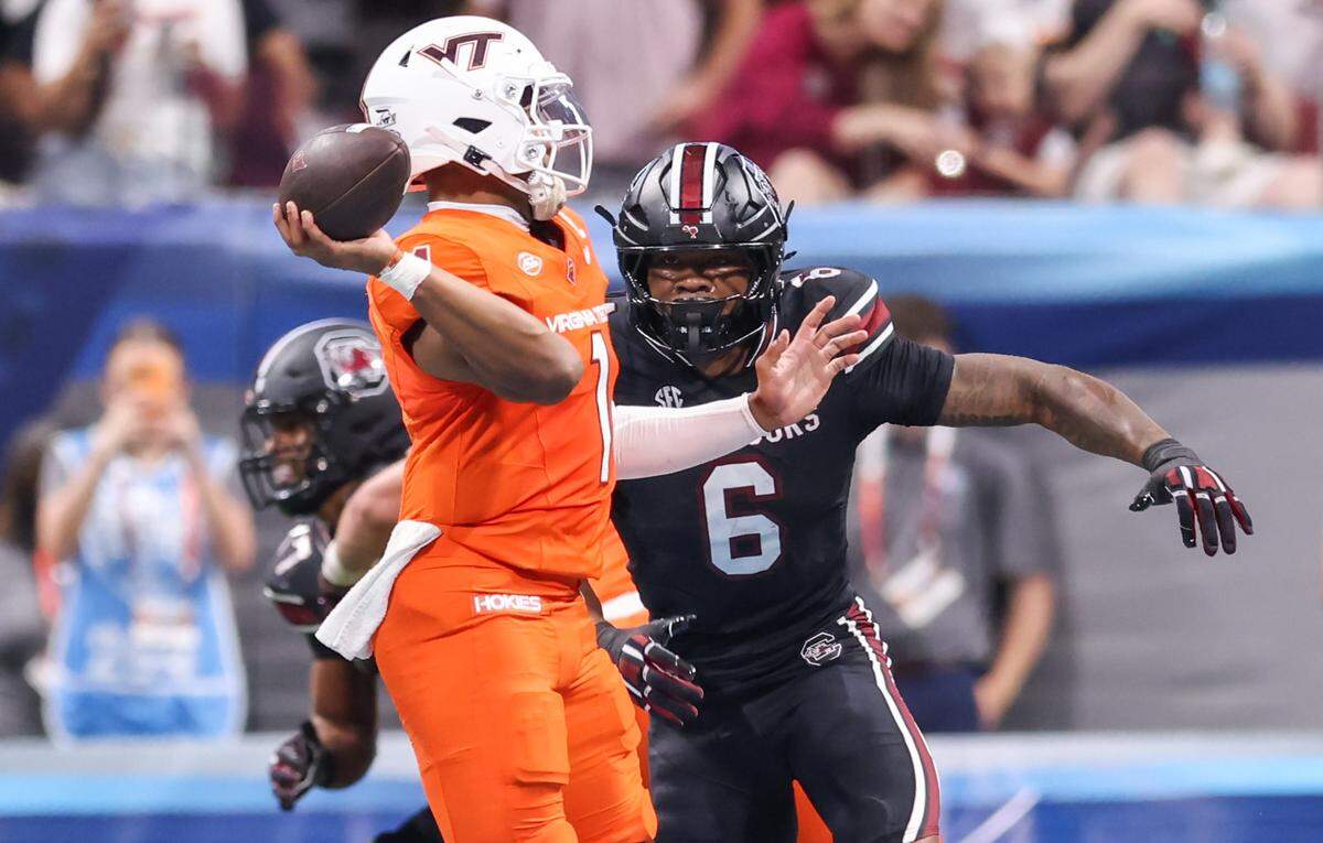 South Carolina edge Dylan Stewart (6) pressures Virginia Tech quarterback Kyron Drones (1) on Sunday at Mercedes-Benz Stadium in Atlanta. The Gamecocks and Hokies faced off Aug. 31 in the 2025 Aflac Kickoff Game.