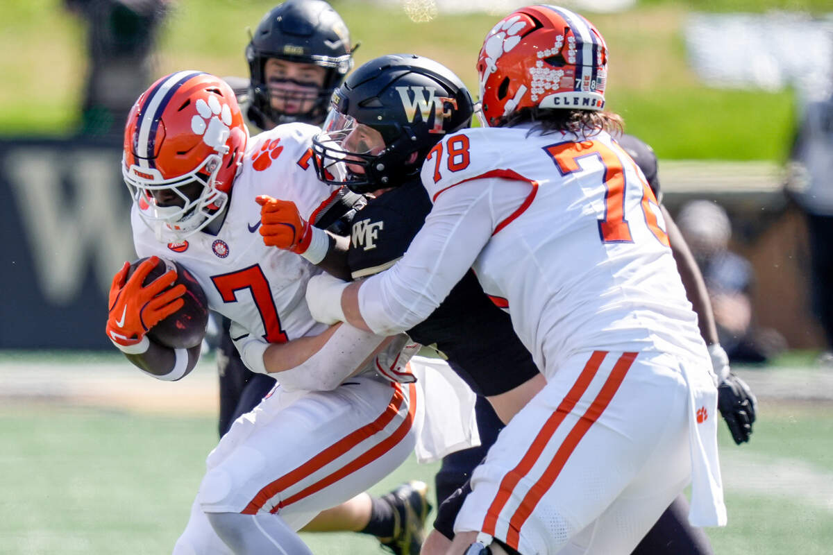 Clemson Tigers running back Phil Mafah (7) is tackled by Wake Forest Demon Deacons linebacker Branson Combs (21) during the first half at Allegacy Federal Credit Union Stadium.