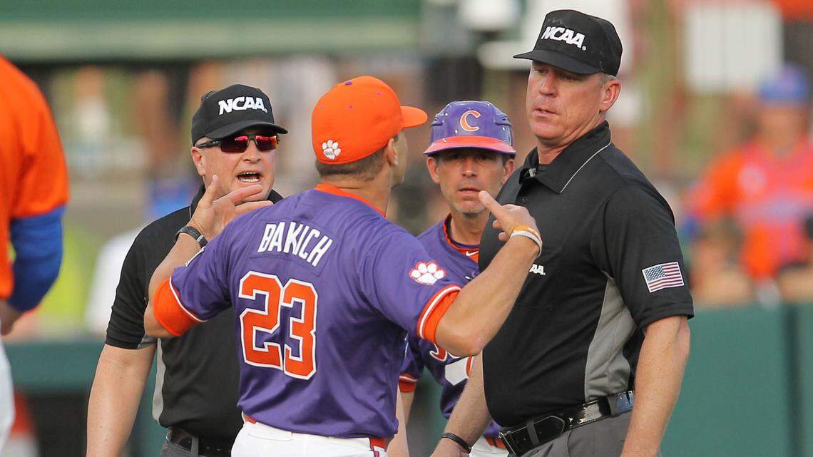 Clemson head coach Erik Bakich is walked back by umpires after being ejected during NCAA Super Regionals action on Sunday, June 9, 2024 in Clemson, S.C.