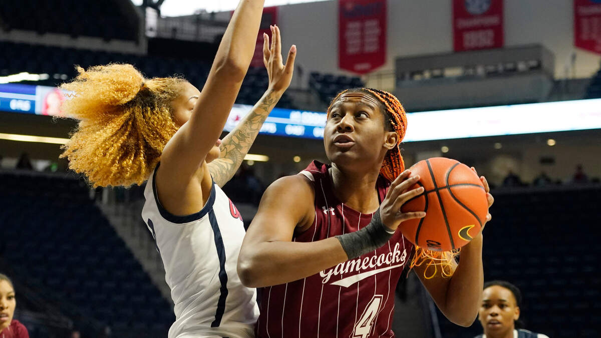 South Carolina forward Aliyah Boston (4) pushes into Mississippi forward Shakira Austin (0) as she tries to shoot a basket during the first half of an NCAA college basketball game in Oxford, Miss., Sunday, Feb. 27, 2022. (AP Photo/Rogelio V. Solis)
