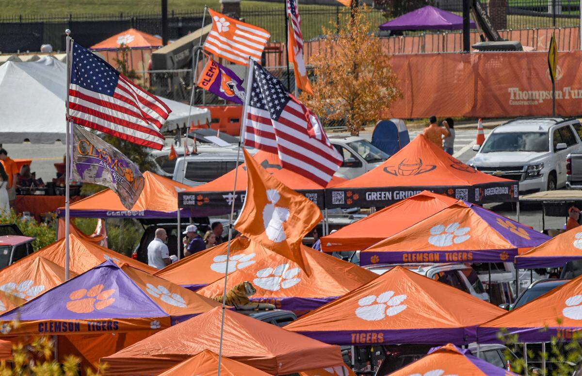 Nov 2, 2024; Clemson, South Carolina, USA; Fall colors surround football fans tailgating before a game between the Clemson Tigers and the Louisville Cardinals at Memorial Stadium.