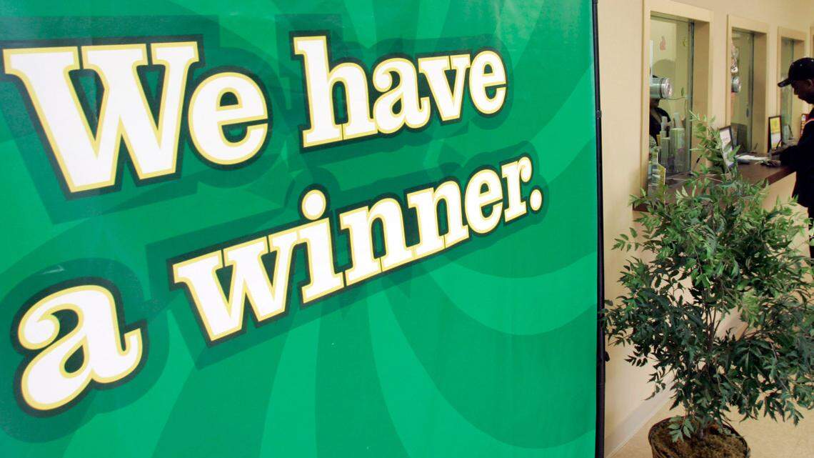 The woman couldn’t get her shoes on fast enough to leave her house and claim her top prize, lottery officials said. (AP Photo/Chuck Burton)