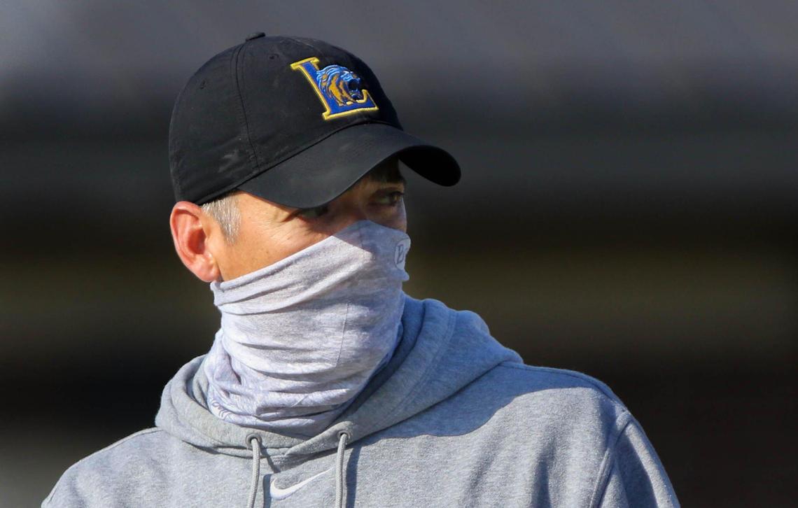 Lexington High football Coach Perry Woolbright wears a mask to help prevent the spread of the coronavirus during practice at Lexington High School.