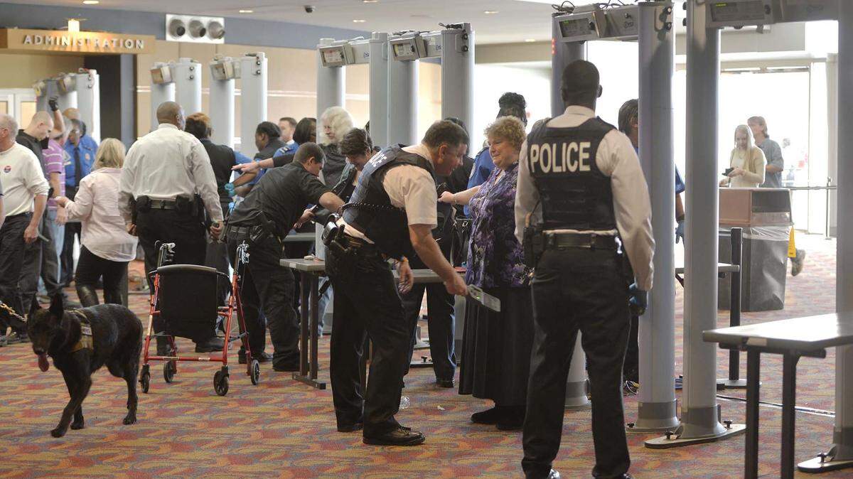 Secret Service agents and local law enforcement officer teams, like those seen here at a 2015 Trump rally in Georgia, will check everyone going into Airport High School.