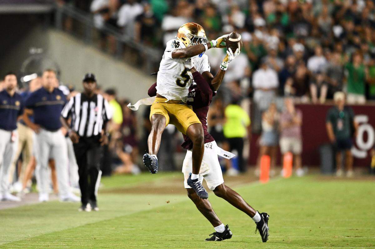 Aug 31, 2024; College Station, Texas, USA; Notre Dame Fighting Irish wide receiver Beaux Collins (5) catches a pass as Texas A&M Aggies defensive back Dashawn Fillmore (26) attempts to break up the play in the fourth quarter at Kyle Field.