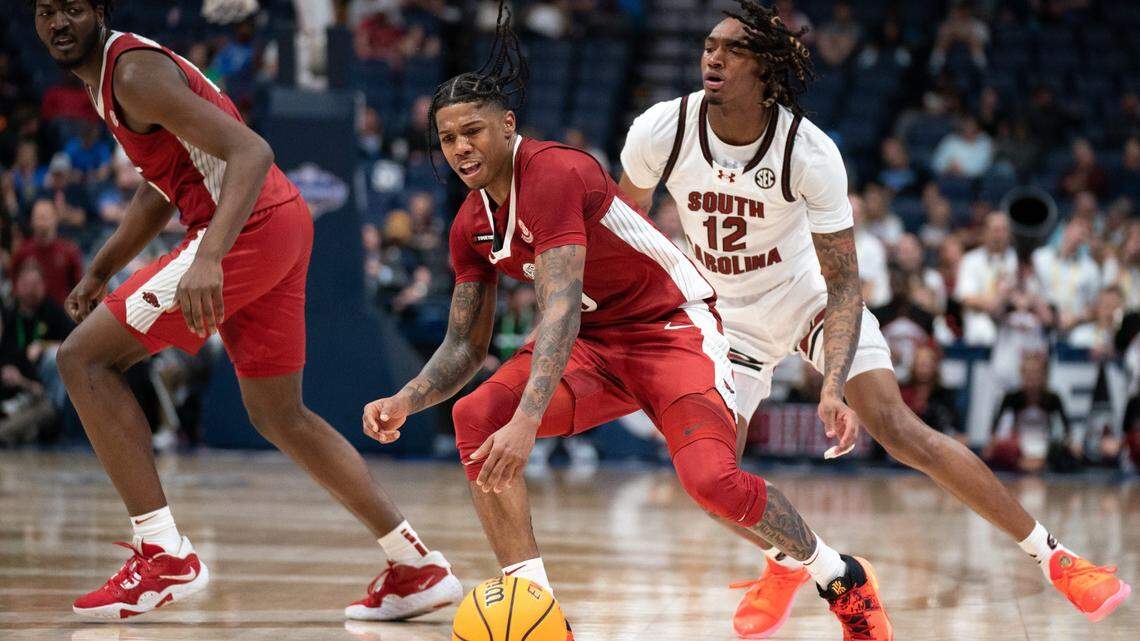 Arkansas Razorbacks guard Khalif Battle (0) drives to the paint while pressured by South Carolina Gamecocks guard Zachary Davis (12) during their second round game of the SEC Men’s Basketball Tournament at Bridgestone Arena in Nashville, Tenn., Thursday, March 14, 2024.