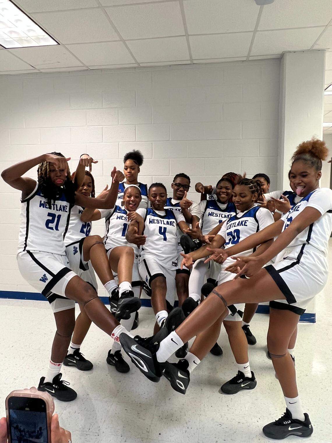 The Westlake High School girls basketball team poses with A’One Nike sneakers gifted to them by South Carolina WBB (and Westlake alum) star Raven Johnson.