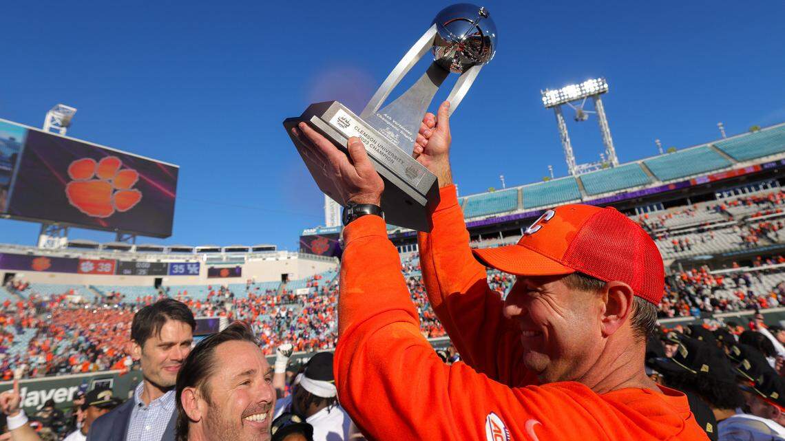 Dec 29, 2023; Jacksonville, FL, USA; Clemson Tigers head coach Dabo Swinney is presented with the Gator Bowl trophy after beating the Kentucky Wildcats at EverBank Stadium.