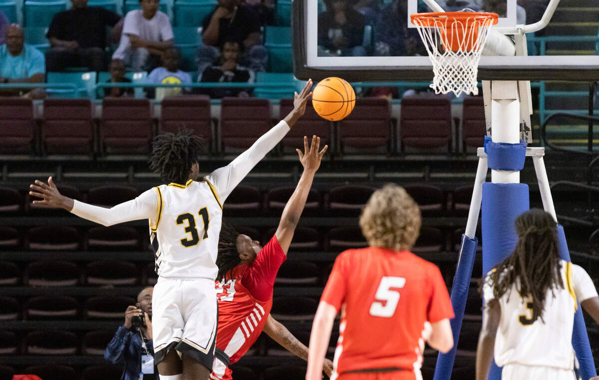 Brandon Crawford (31) of Irmo blocks the shot of Deandre Huggins (23) of Hartsville during Irmo’s game against Hartsville at the Florence Center in Florence on Friday, February 24, 2023.