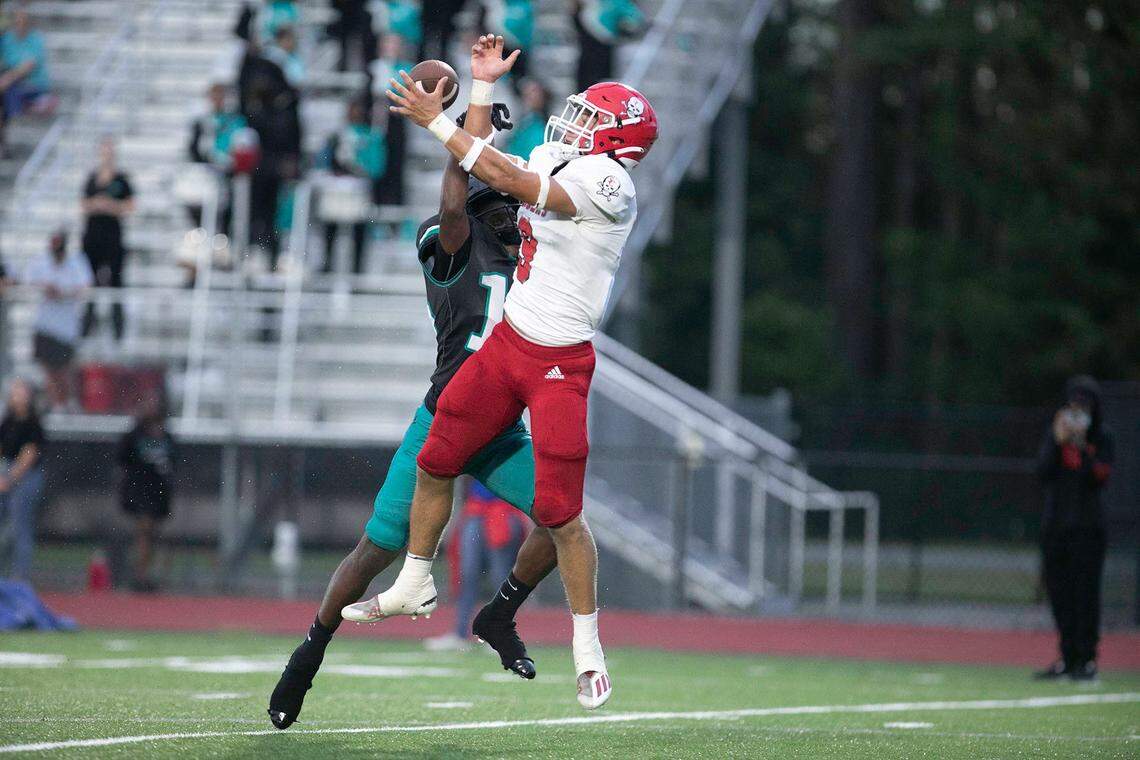 Savannah Christian’s David Bucey leaps over an Island’s defender and comes down with the catch during a game on Aug. 26, 2022.