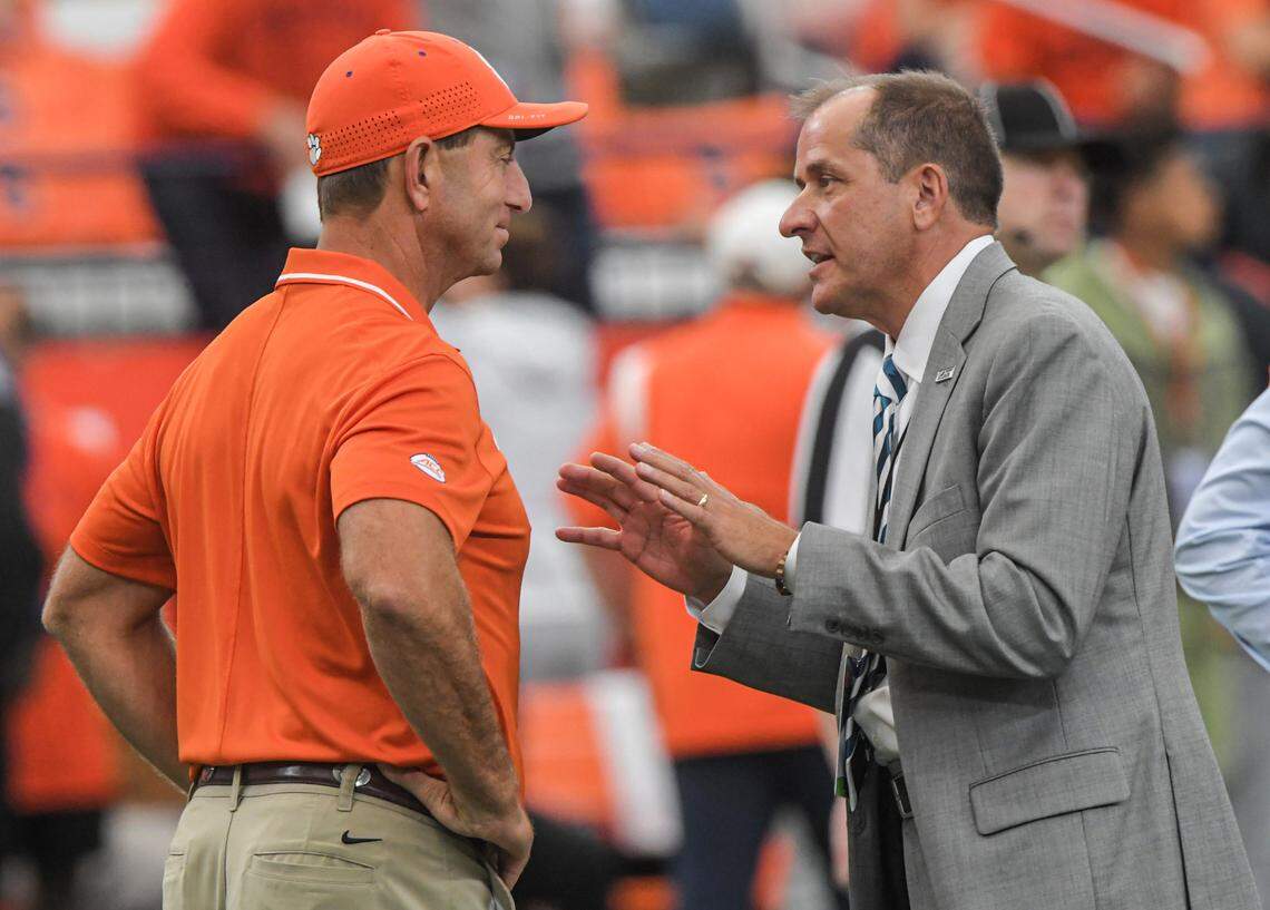 Sep 30, 2023; Syracuse, New York, USA; Clemson head coach Dabo Swinney and ACC Commissioner Jim Phillips talk before the game at JMA Wireless Dome.
