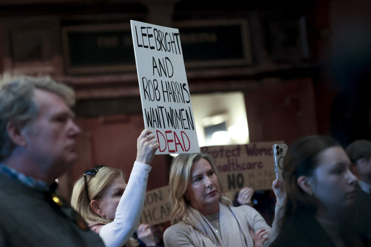 Eve Stacey, left, and Christine Simmons hold a sign during a press conference in the State House lobby on Tuesday, Jan. 13, 2026. During the press conference, Sen. Lee Bright and State Rep. Rob Harris discussed their legislation, The South Carolina Prenatal Equal Protection Act.