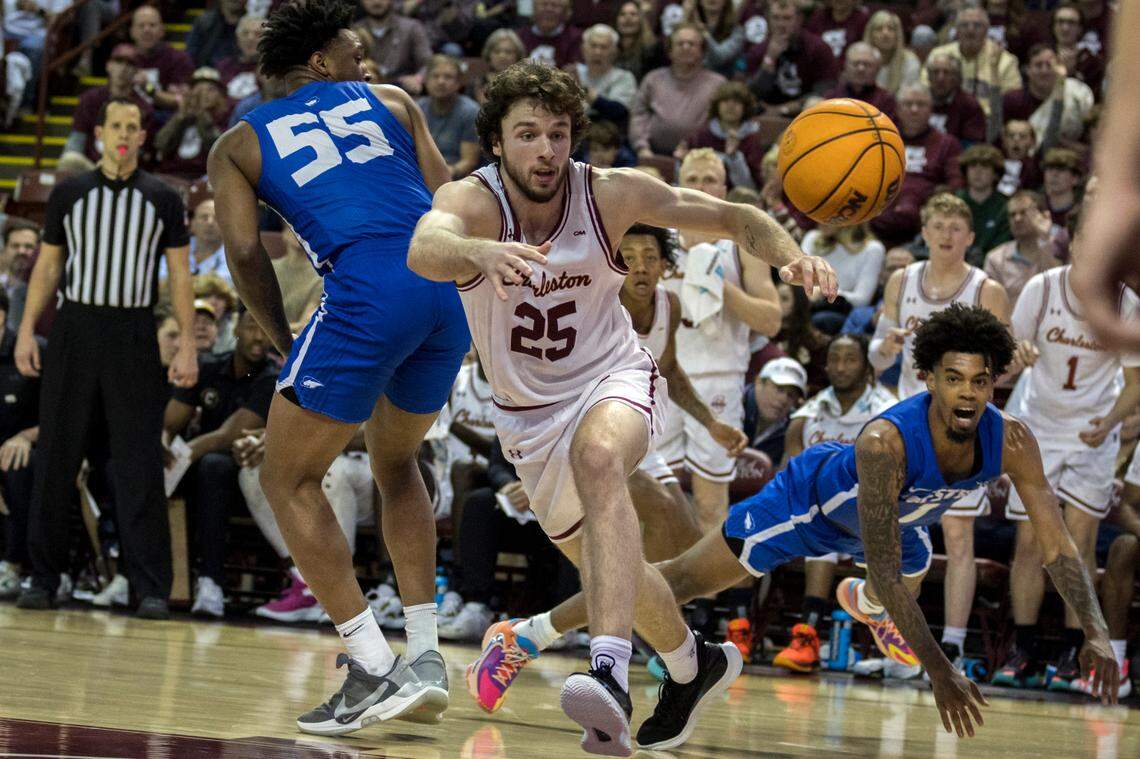 Charleston forward Ben Burnham (25) looses the ball while being guarded by Hofstra guard Darlinstone Dubar (55) and guard Aaron Estrada (1) during the second half of an NCAA college basketball game, Saturday, Jan. 28, 2023, in Charleston, S.C. (AP Photo/Stephen B. Morton)